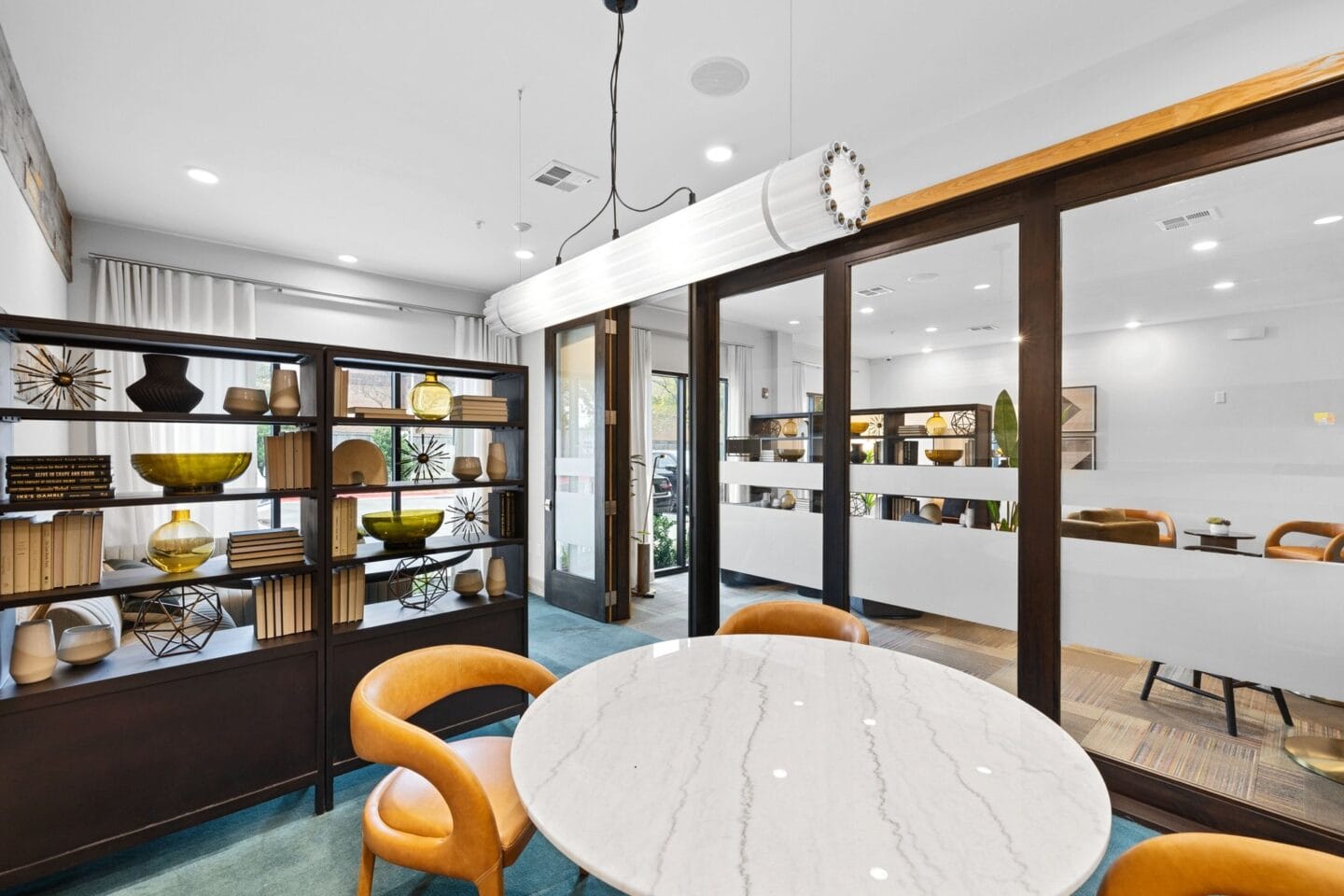 a dining room with a table and chairs and a display case