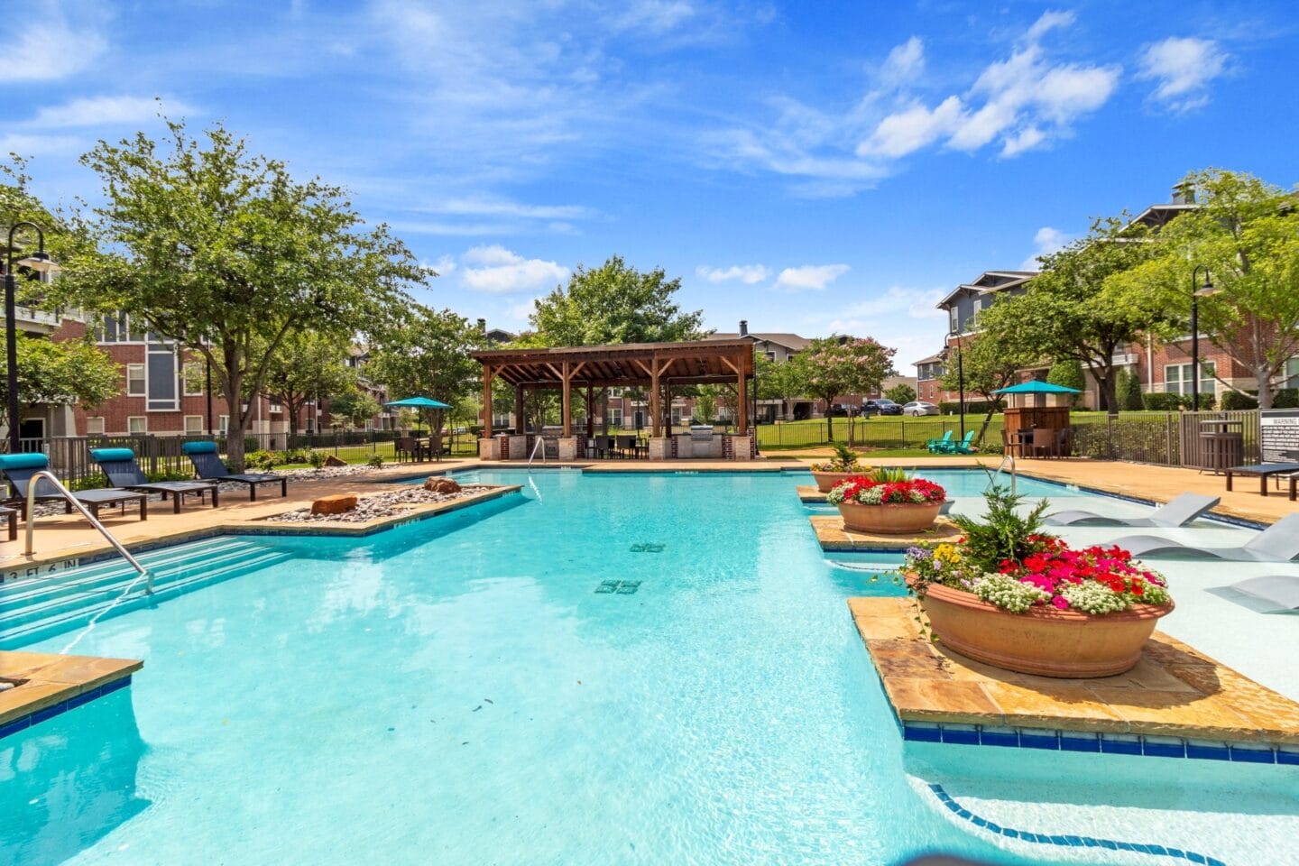 our apartments have a resort style pool with seating areas and a gazebo