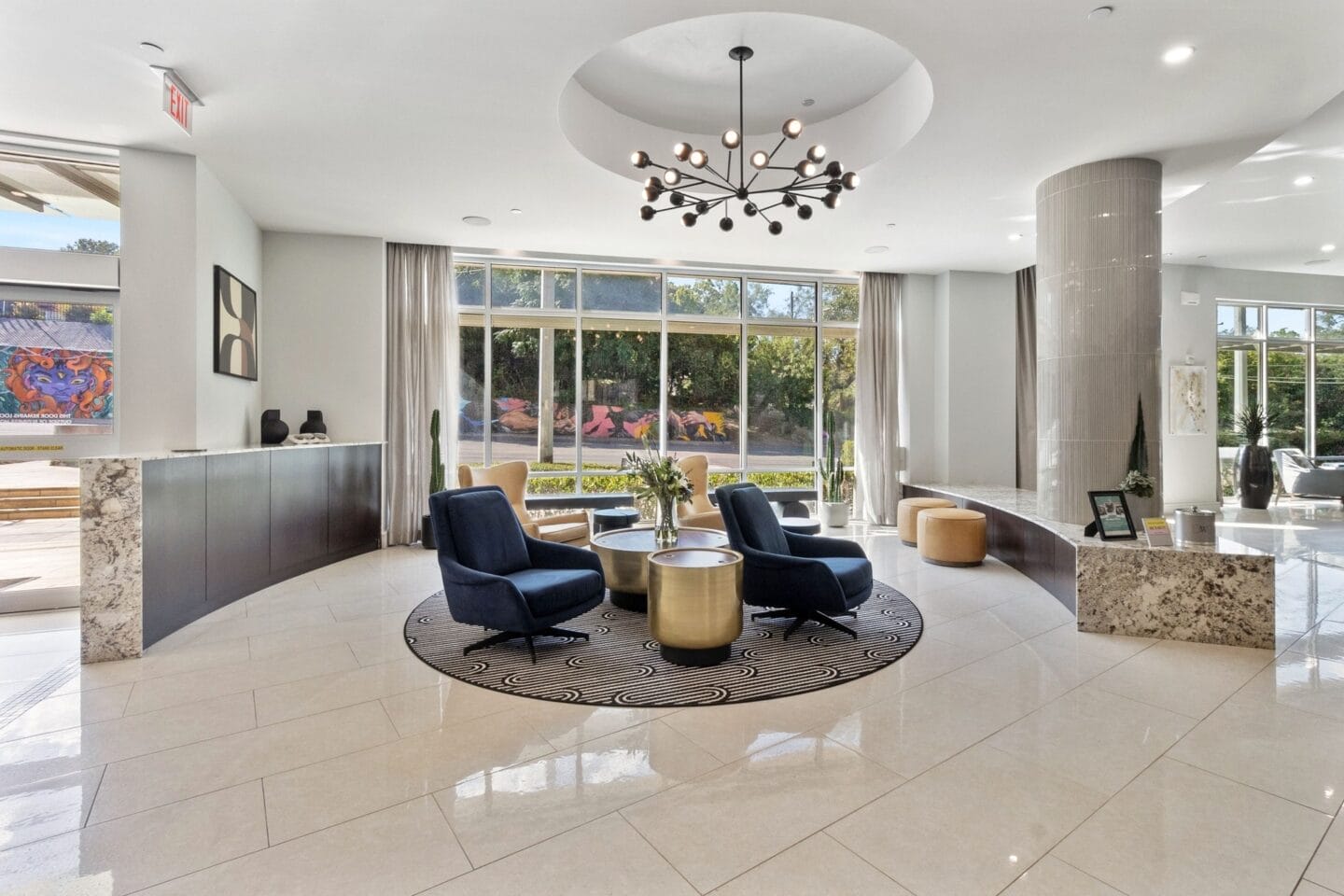 a lobby with a table and chairs and a large window