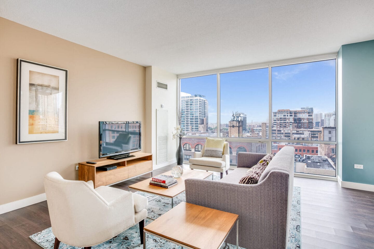 Model apartment with floor to ceiling window with city views at Flair Tower, Chicago, Illinois