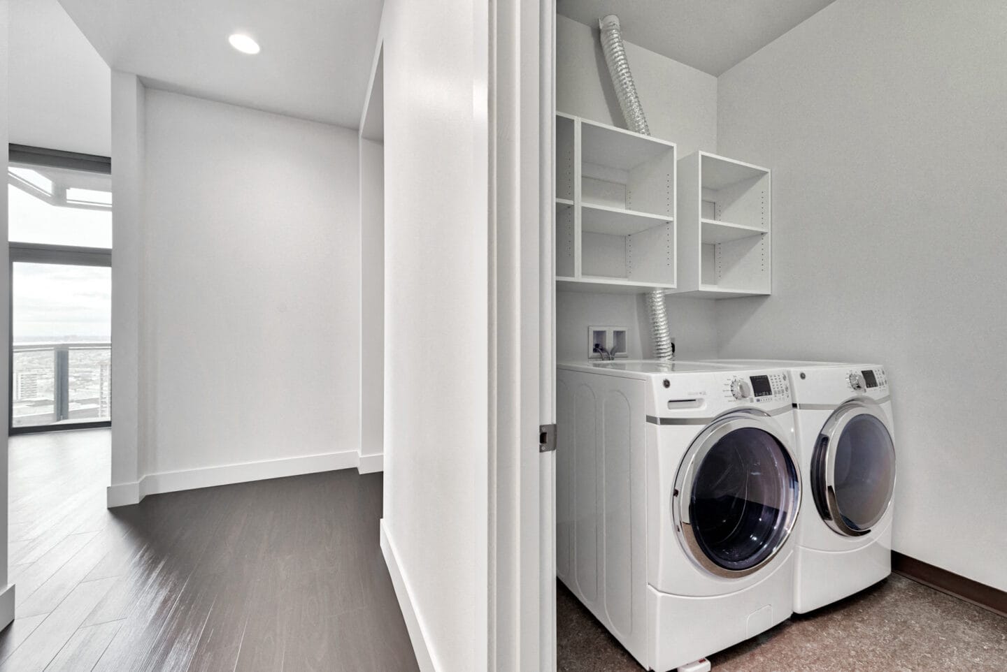 Laundry rooms with front loading side-by-side washer and dryers at Cirrus, Seattle, Washington