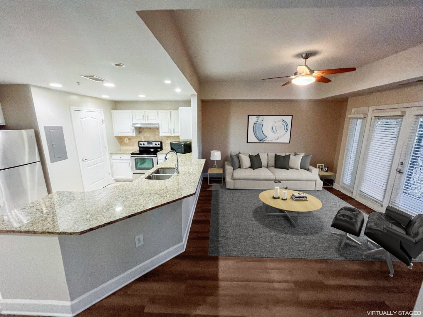 a living room and kitchen with a couch and a table