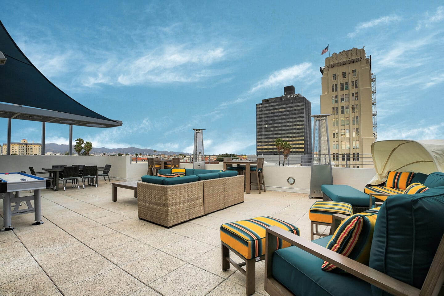 Enjoy the rooftop lounge at 5550 Wilshire at Miracle Mile by Windsor with views of the Hollywood Sign in Los Angeles 90036