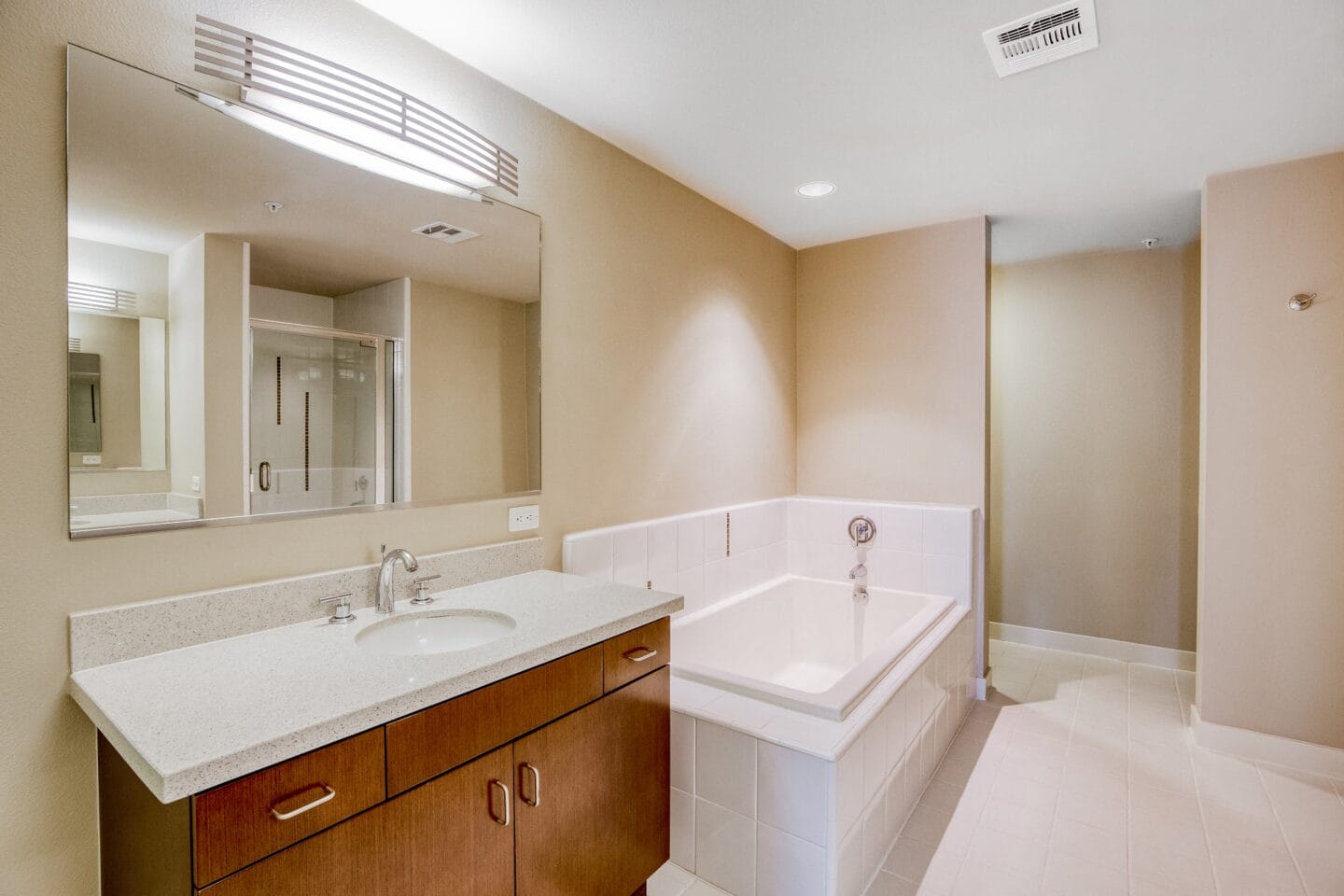 a bathroom with a bathtub sink and mirror