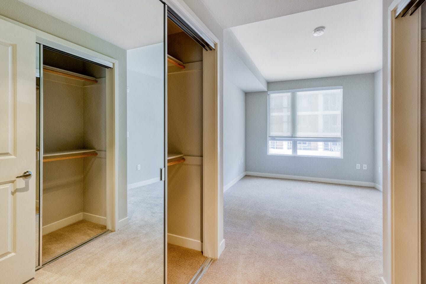 a bedroom with a closet and a window