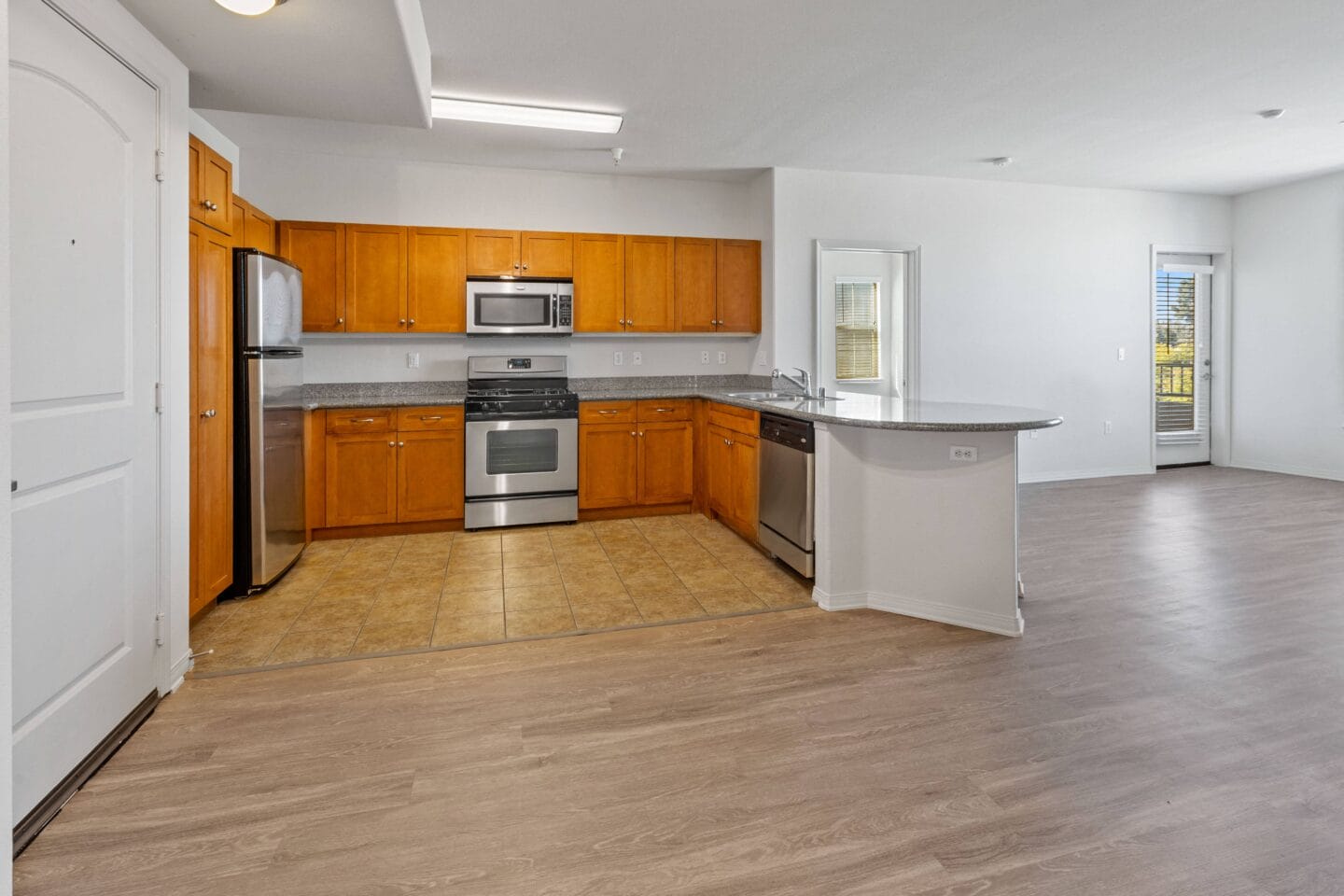 a kitchen with wooden cabinets and stainless steel appliances