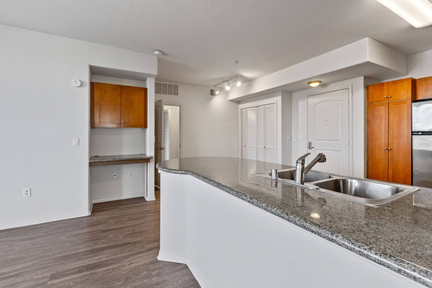 a kitchen with granite countertops and a stainless steel sink