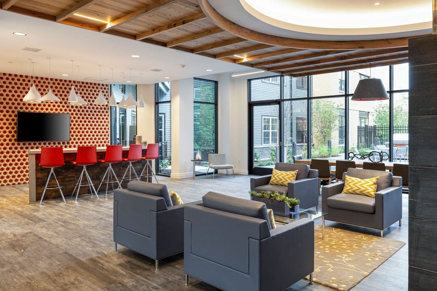 The Entertainment Lounge features bar seating and large screen TV at Edison on the Charles by Windsor, Massachusetts, 02453