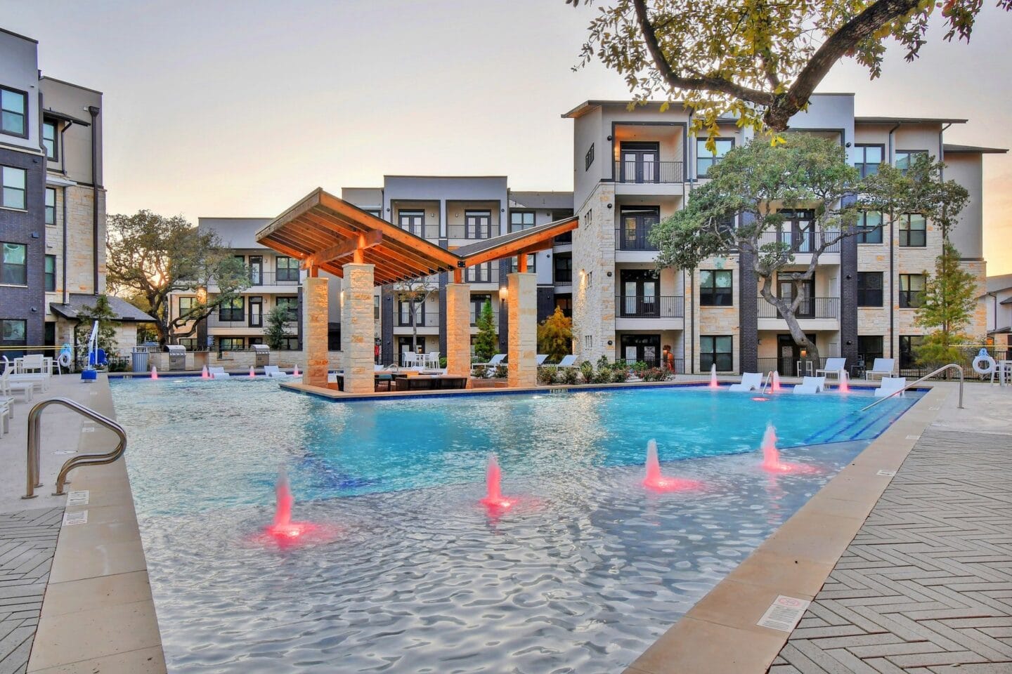 The resort style pool lit up at night at Windsor Ridge, Austin, TX