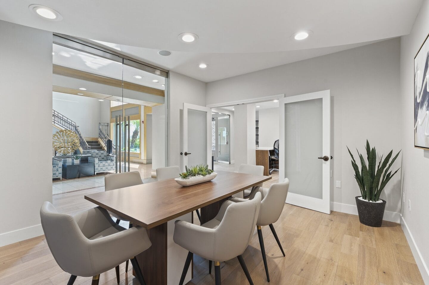 a dining room with a wooden table and chairs