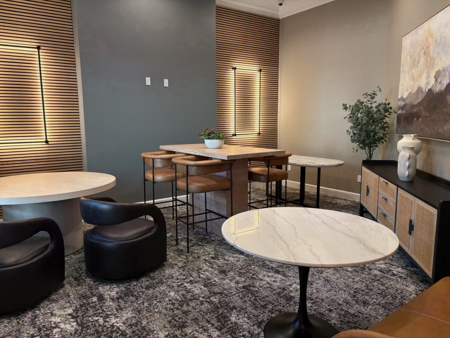 A modern dining area with a round table and chairs.