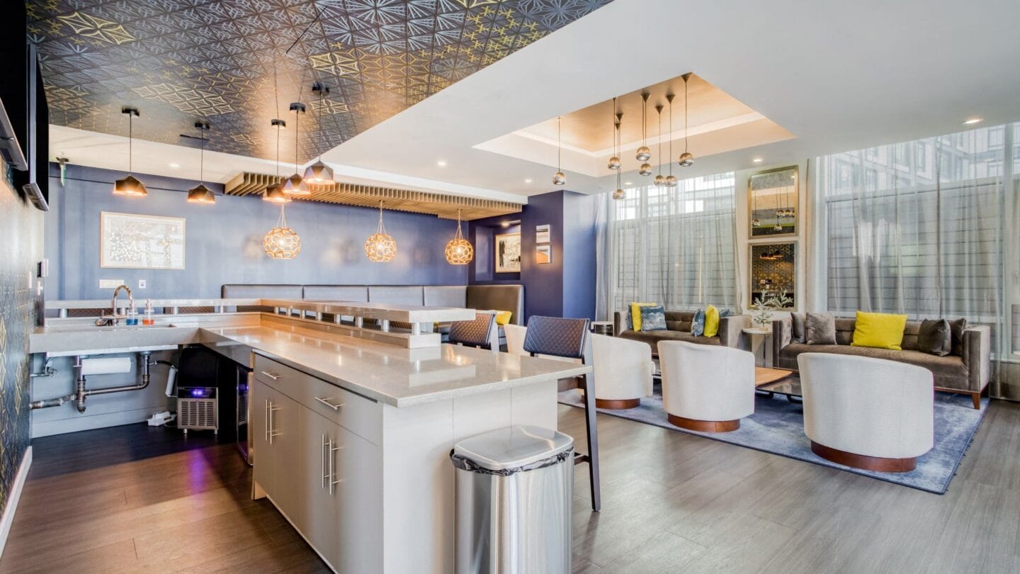 a kitchen with a large island next to a living room