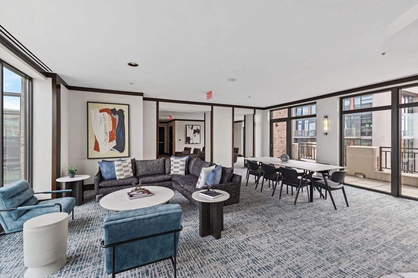 a living room with couches and chairs and a table and chairs in a room