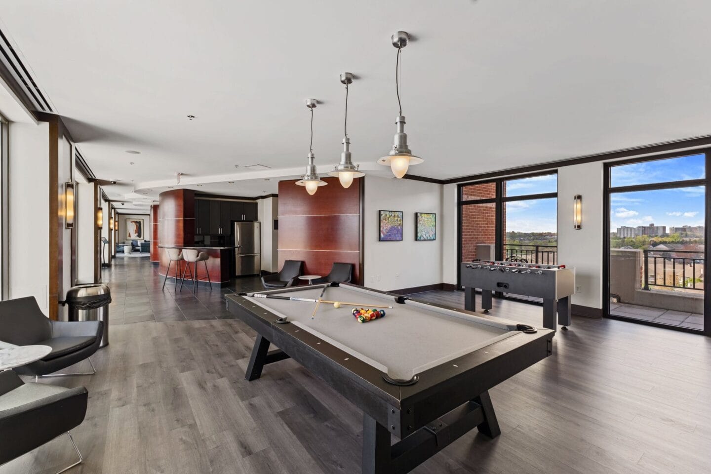 a large living room with a pool table and a bar