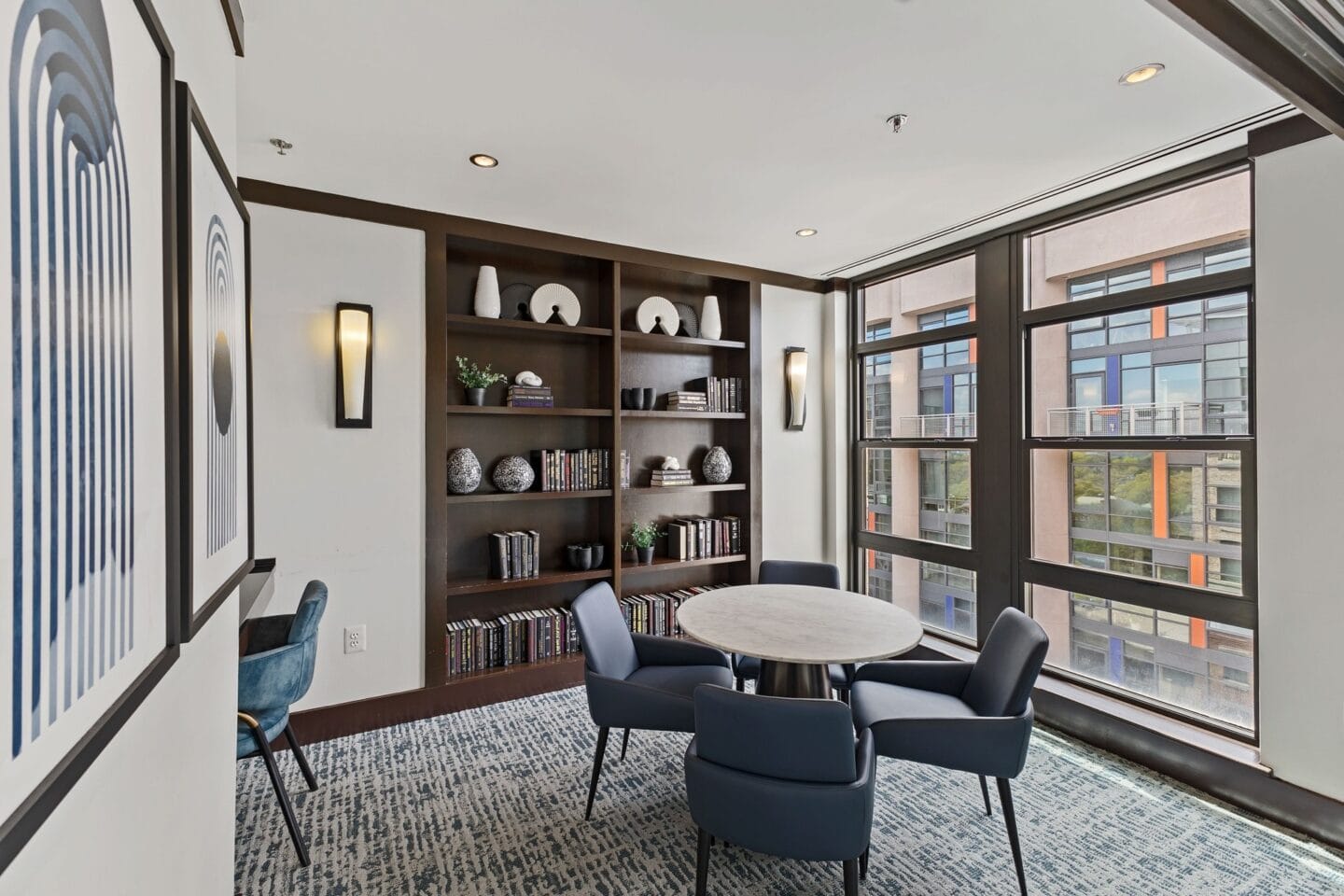 a meeting room with a table and chairs and a large window