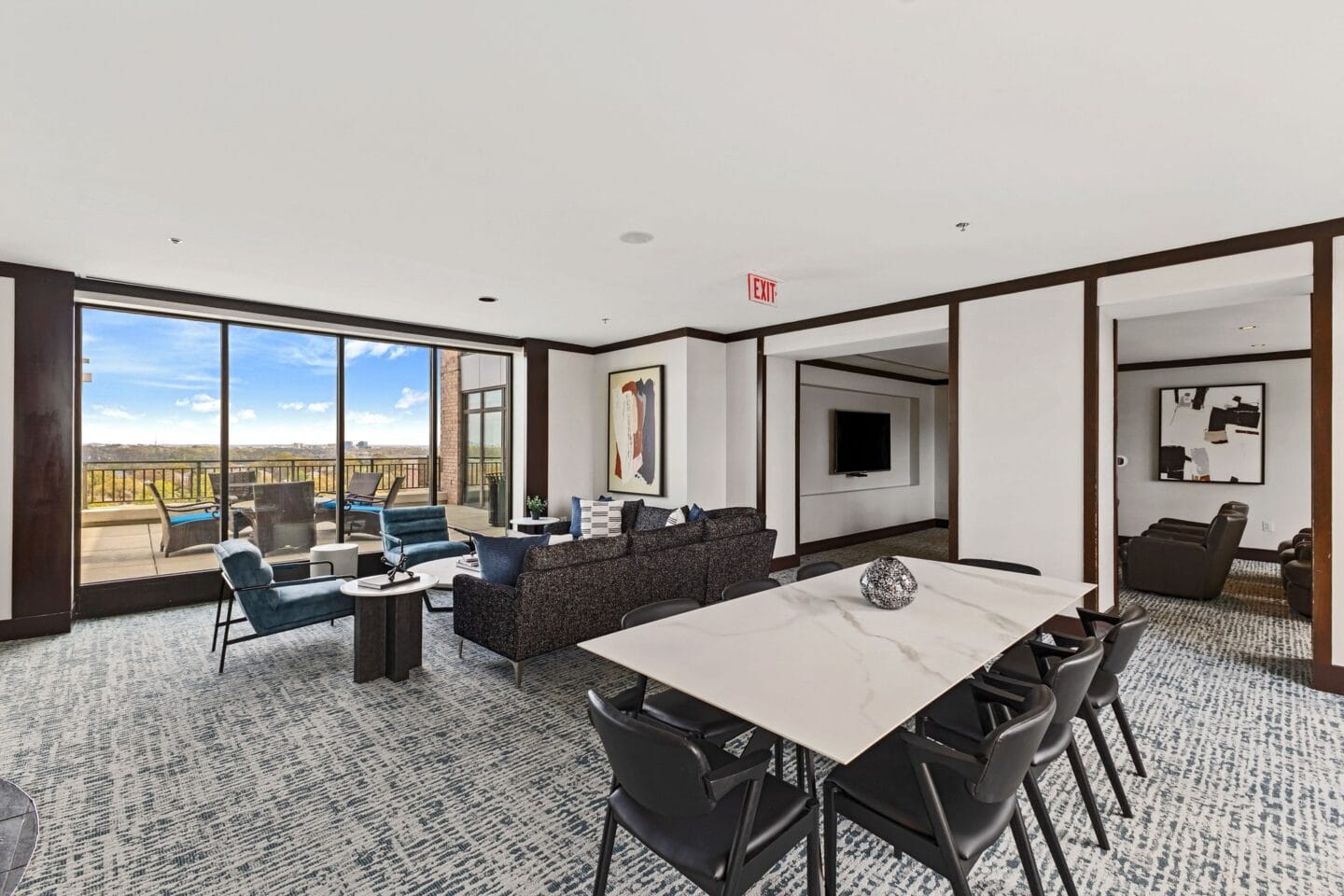 a large living room with a table and chairs and a balcony