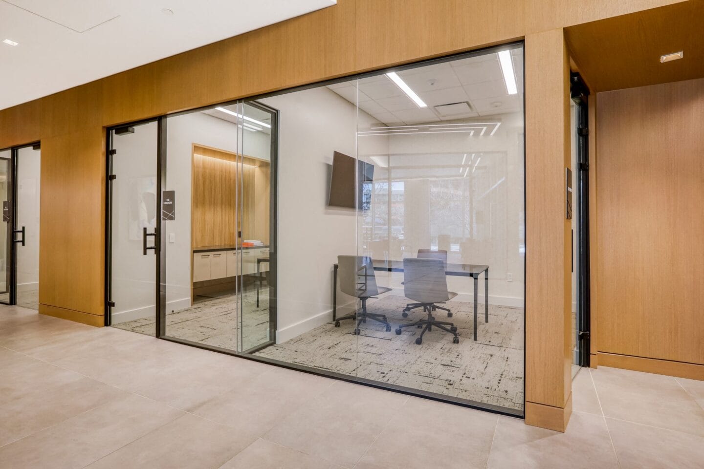 a conference room with glass doors and a carpeted floor