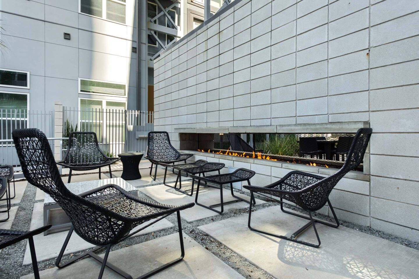 A patio with black chairs and tables at Metro West, Texas, 75024.