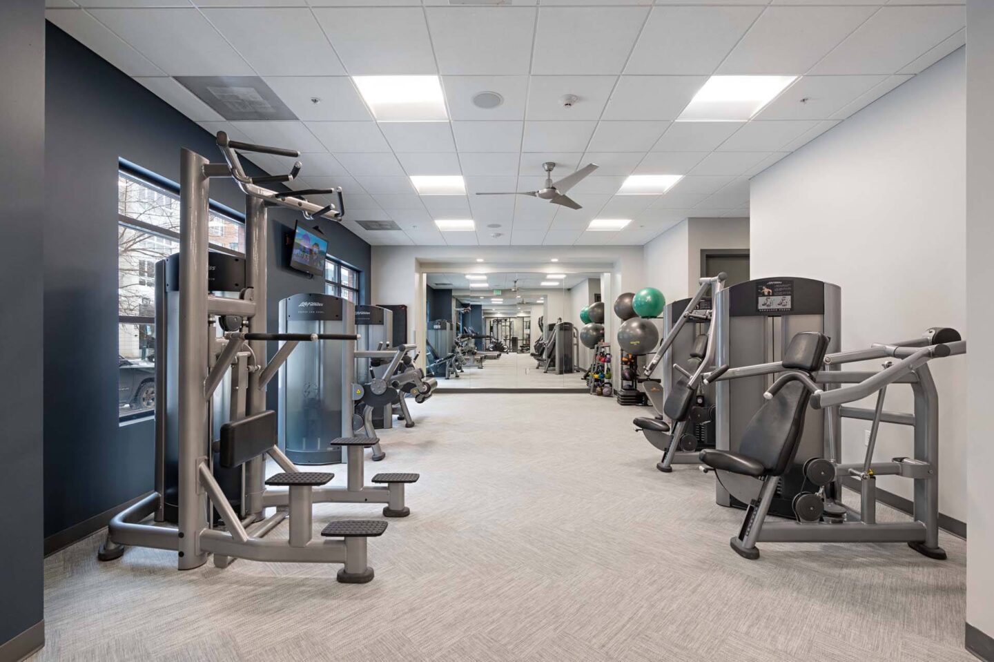 A gym with a variety of equipment including weights and machines at The Manhattan Tower and Lofts, Denver, 80202.