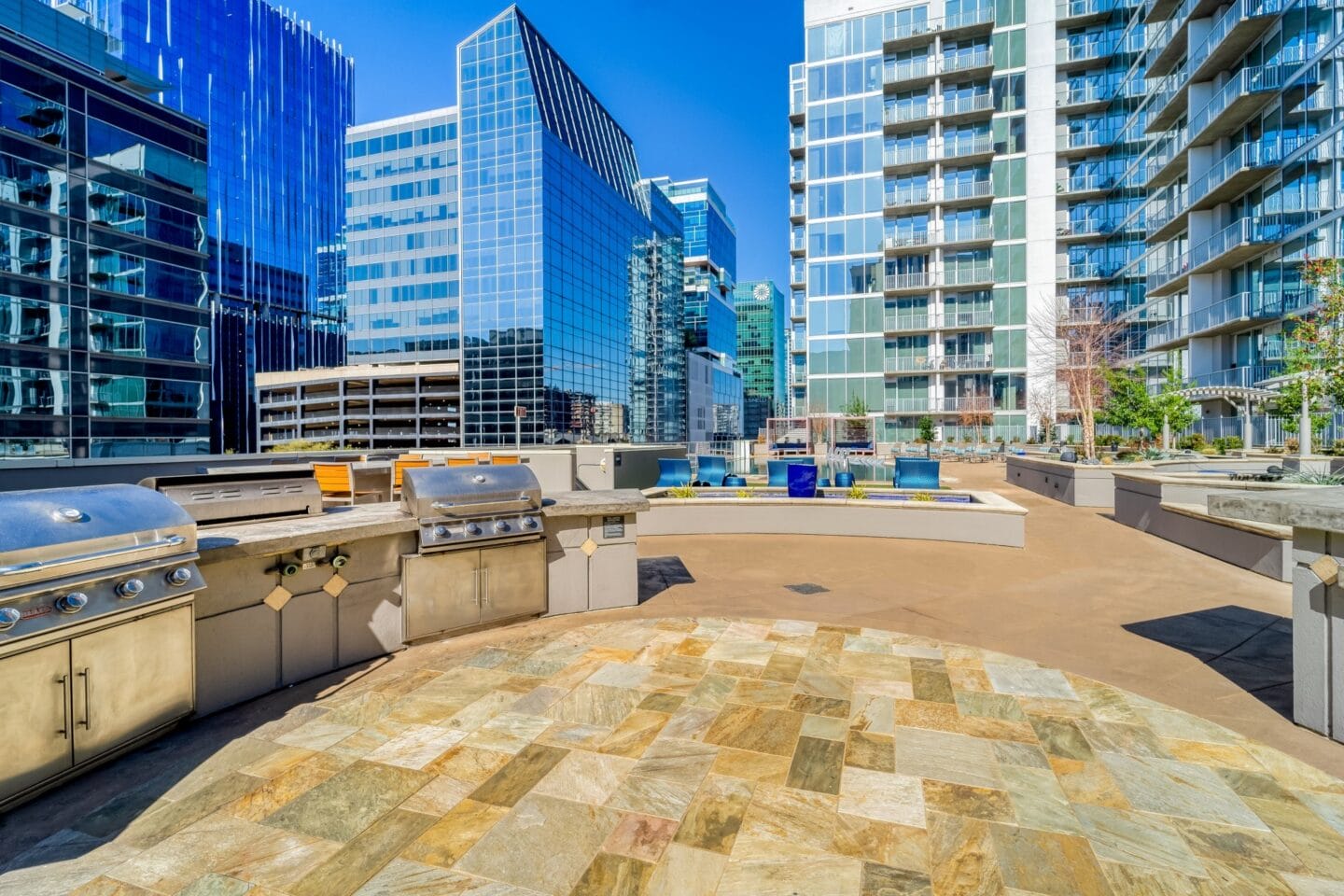 an outdoor kitchen and barbecue area on the roof of a building