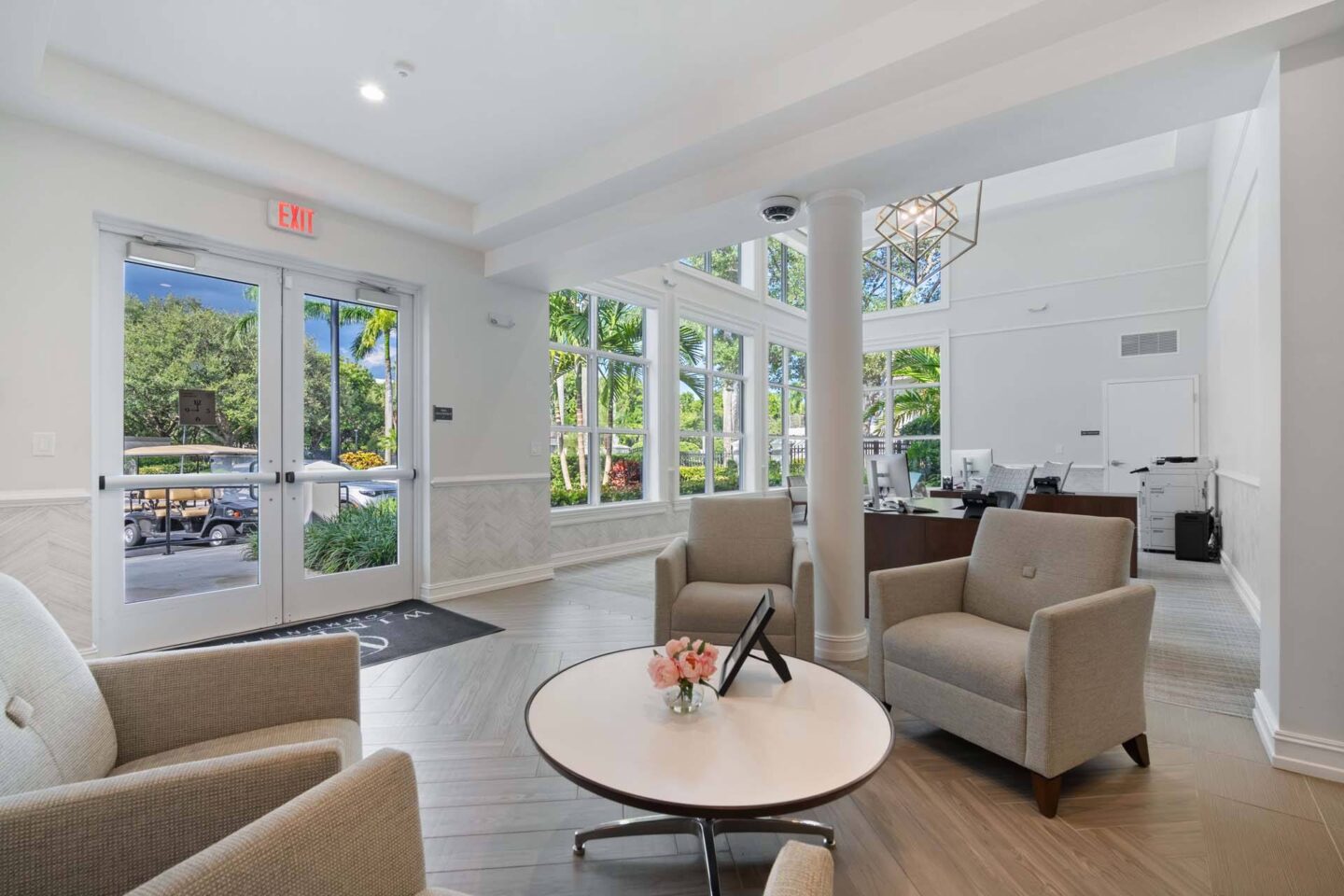 A lobby with a couch, chairs, and a coffee table at Windsor at Miramar, 3701 SW 160th Ave, Miramar, FL 33027.