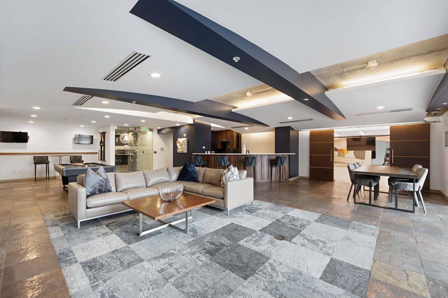 A modern living room with a grey and white checkered rug at The Manhattan Tower and Lofts, Denver, 80202.