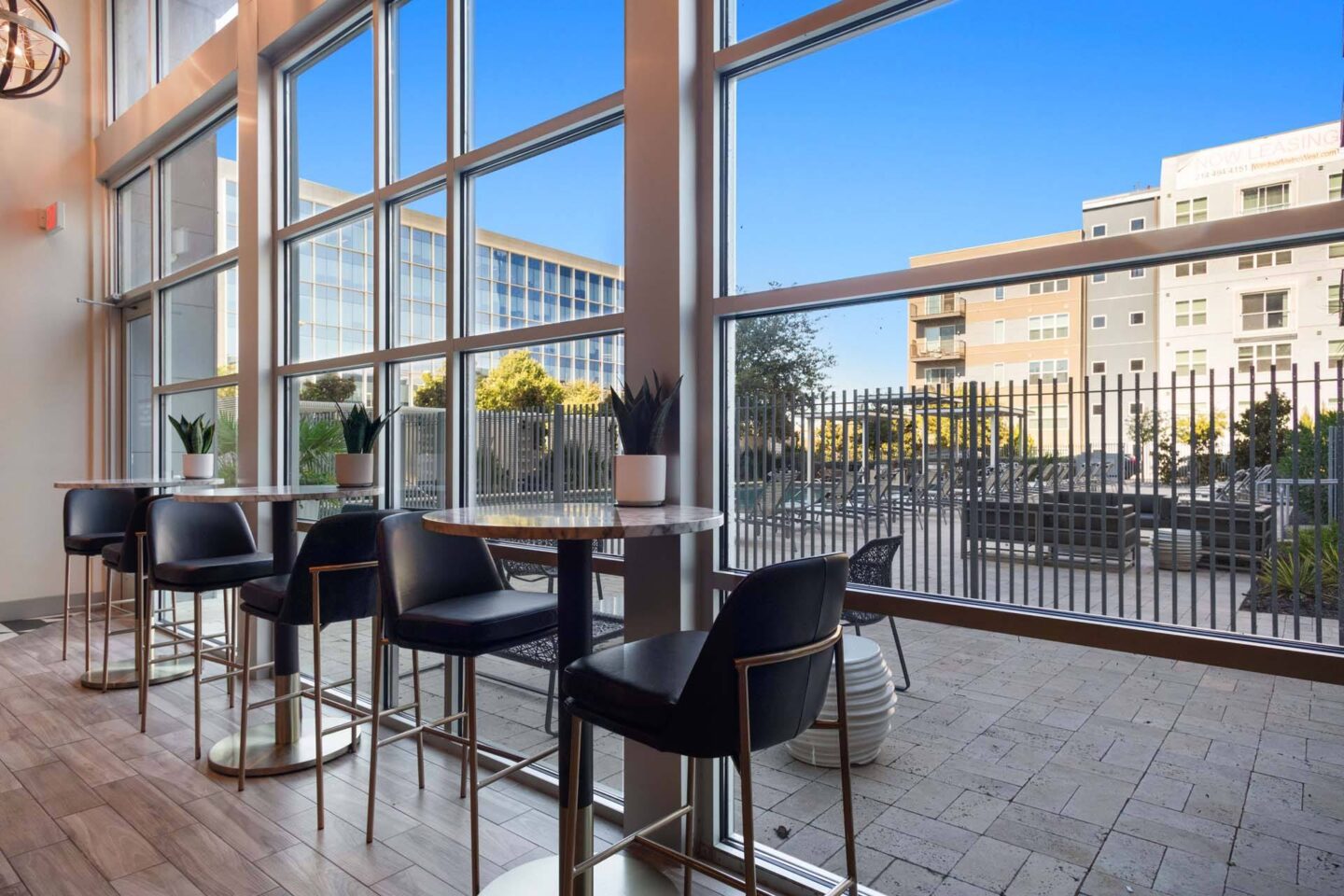 A patio with black chairs and a table with a view of the street at Metro West, Texas, 75024.