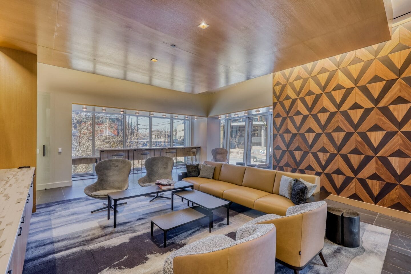 a modern lobby filled with furniture and a large window