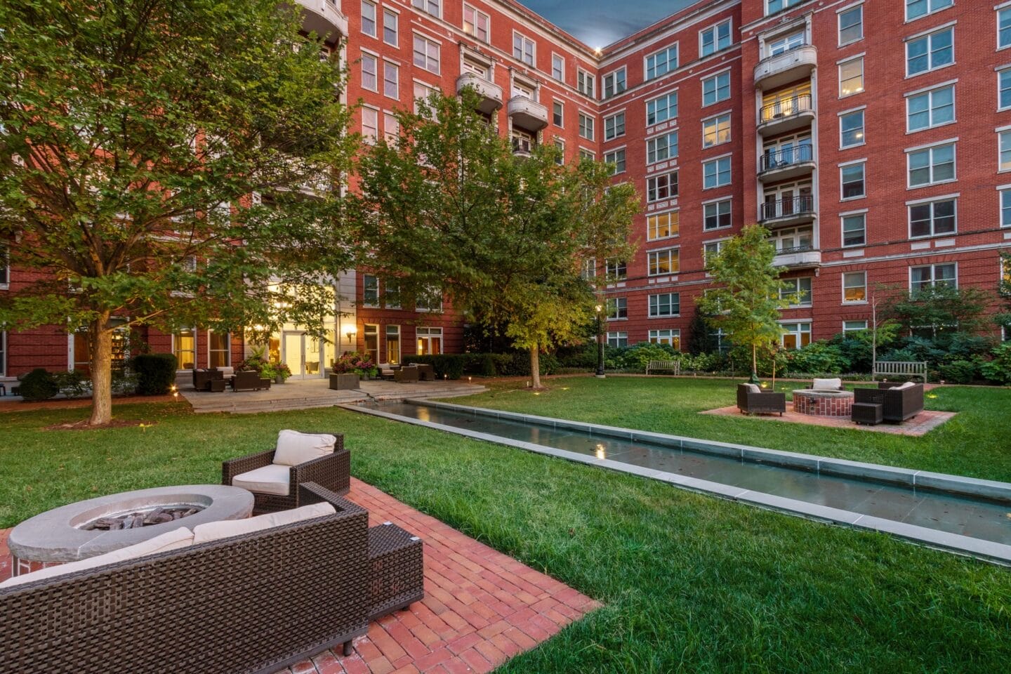 a courtyard with a fire pit and a large building