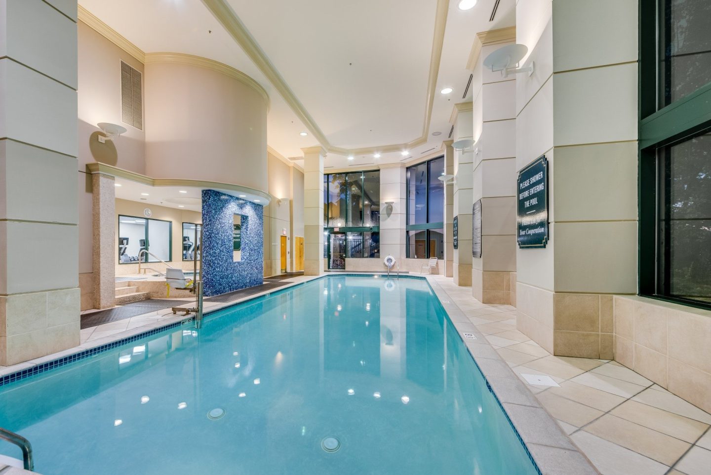 A long rectangular indoor swimming pool with a tiled floor.