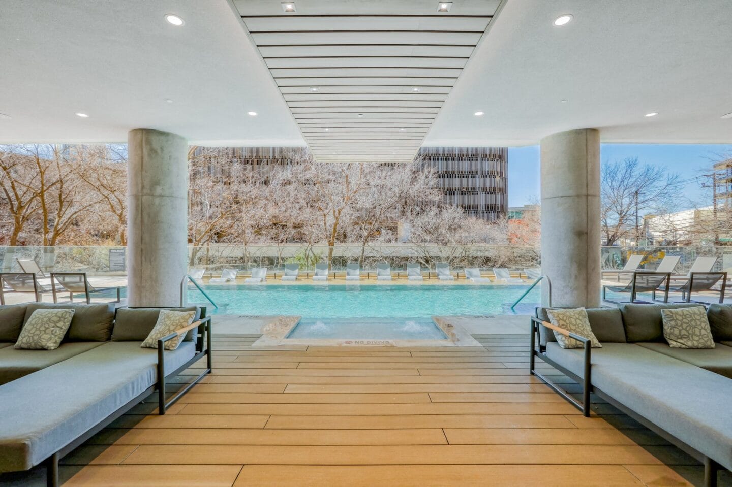 Cabanas with couches and a pool in the background