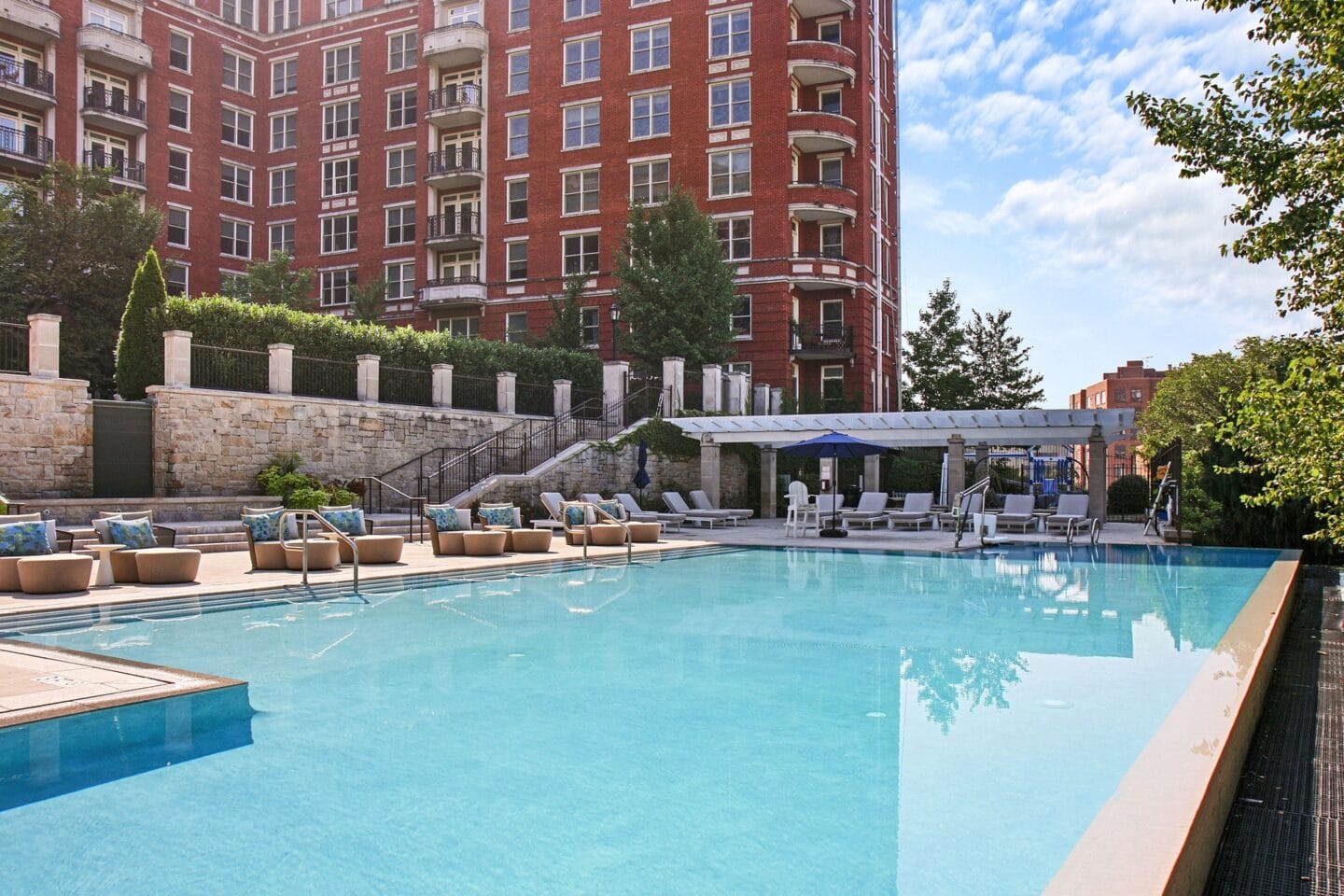 a swimming pool with a hotel in the background