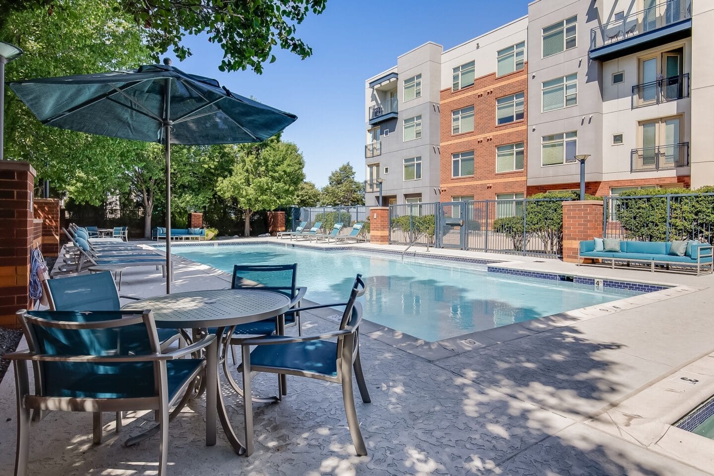 our apartments offer a swimming pool with table and chairs and umbrella