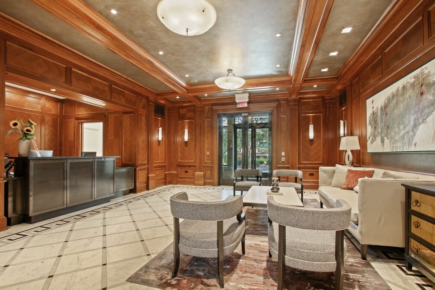 the living room has wood paneling and a marble floor