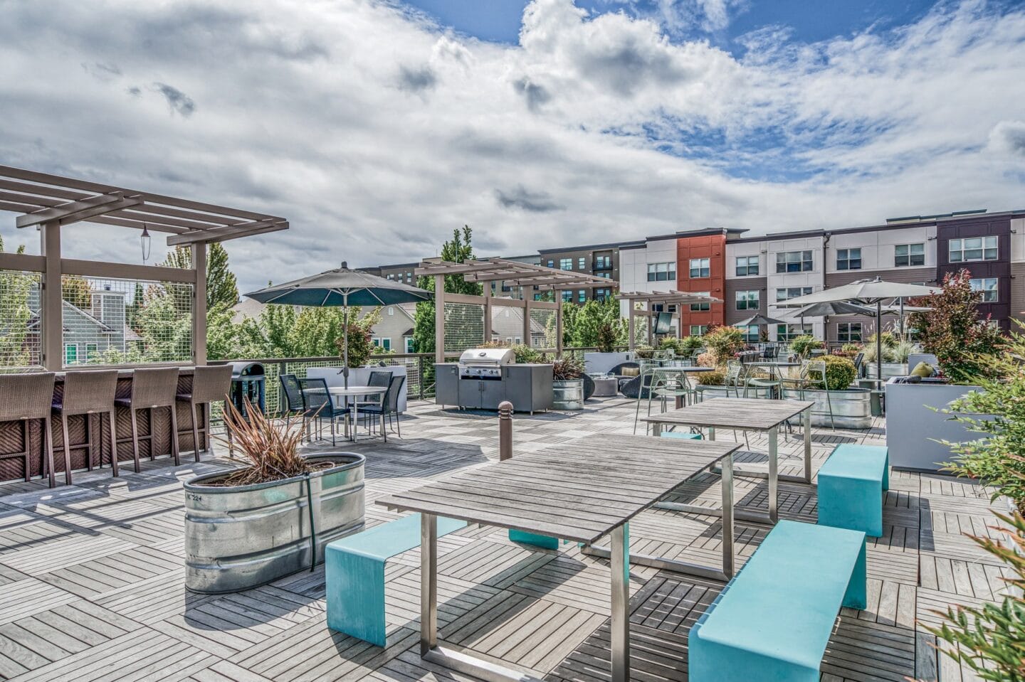 Outdoor patio with tables and benches and umbrellas at Platform 14, Hillsboro, OR