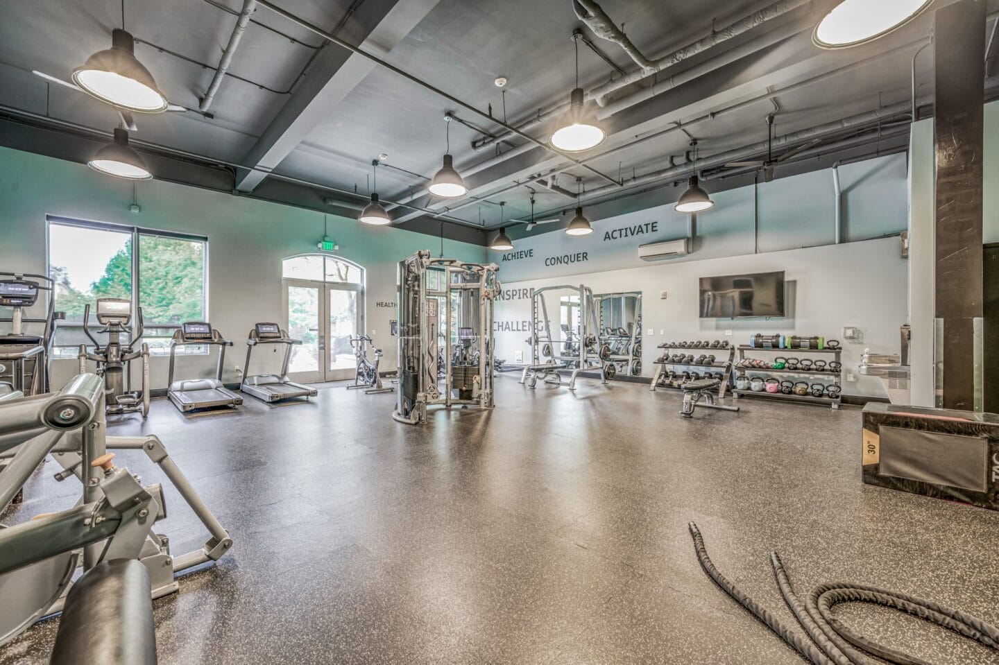 Spacious fitness center with cardio machines and other exercise equipment at Platform 14, Hillsboro, OR