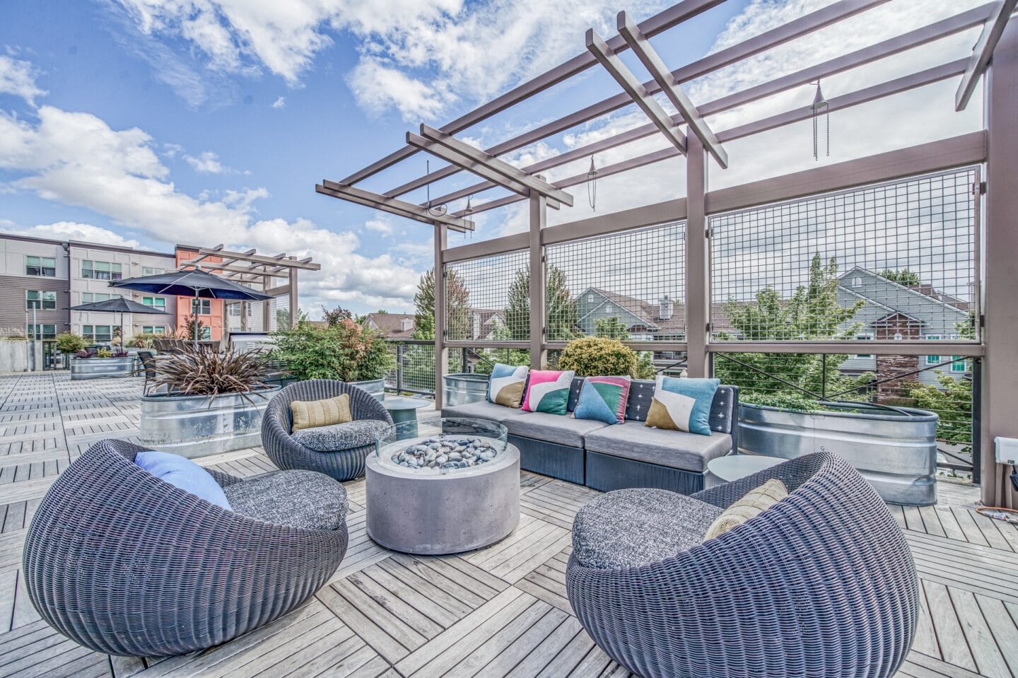 Outdoor patio with wicker furniture and a firepit at Platform 14, Hillsboro, OR