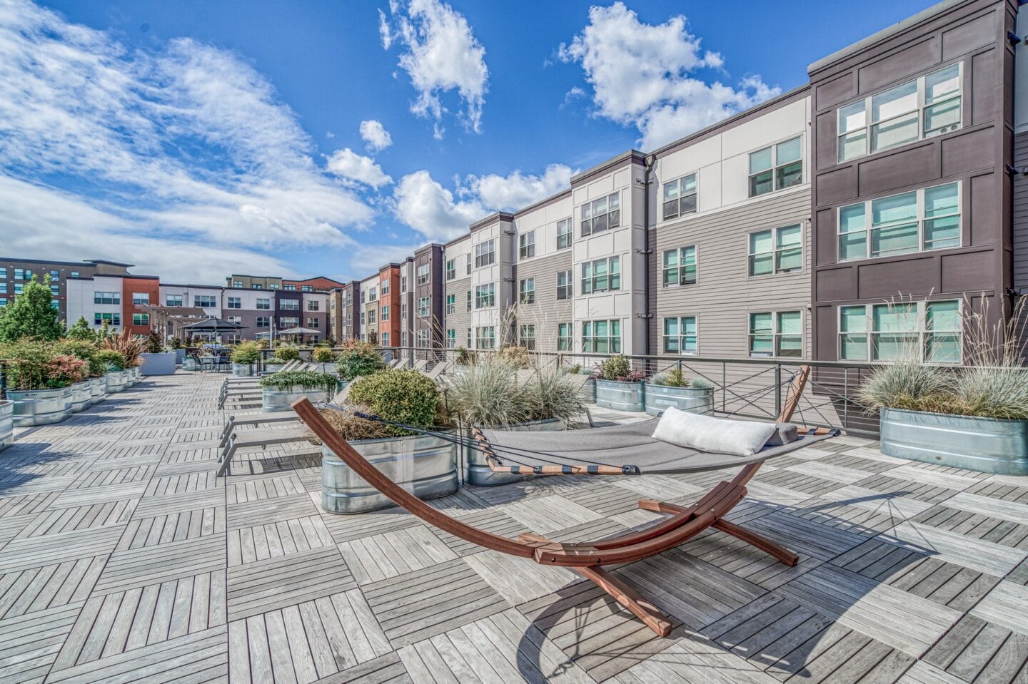 Rooftop deck with hammock chairs and potted plants at Platform 14, Hillsboro, OR