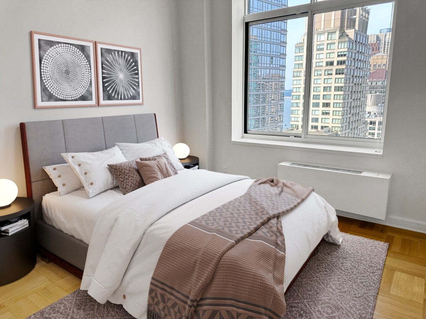 Bedroom with a bed and two windows at The Ashley Apartments, New York, New York