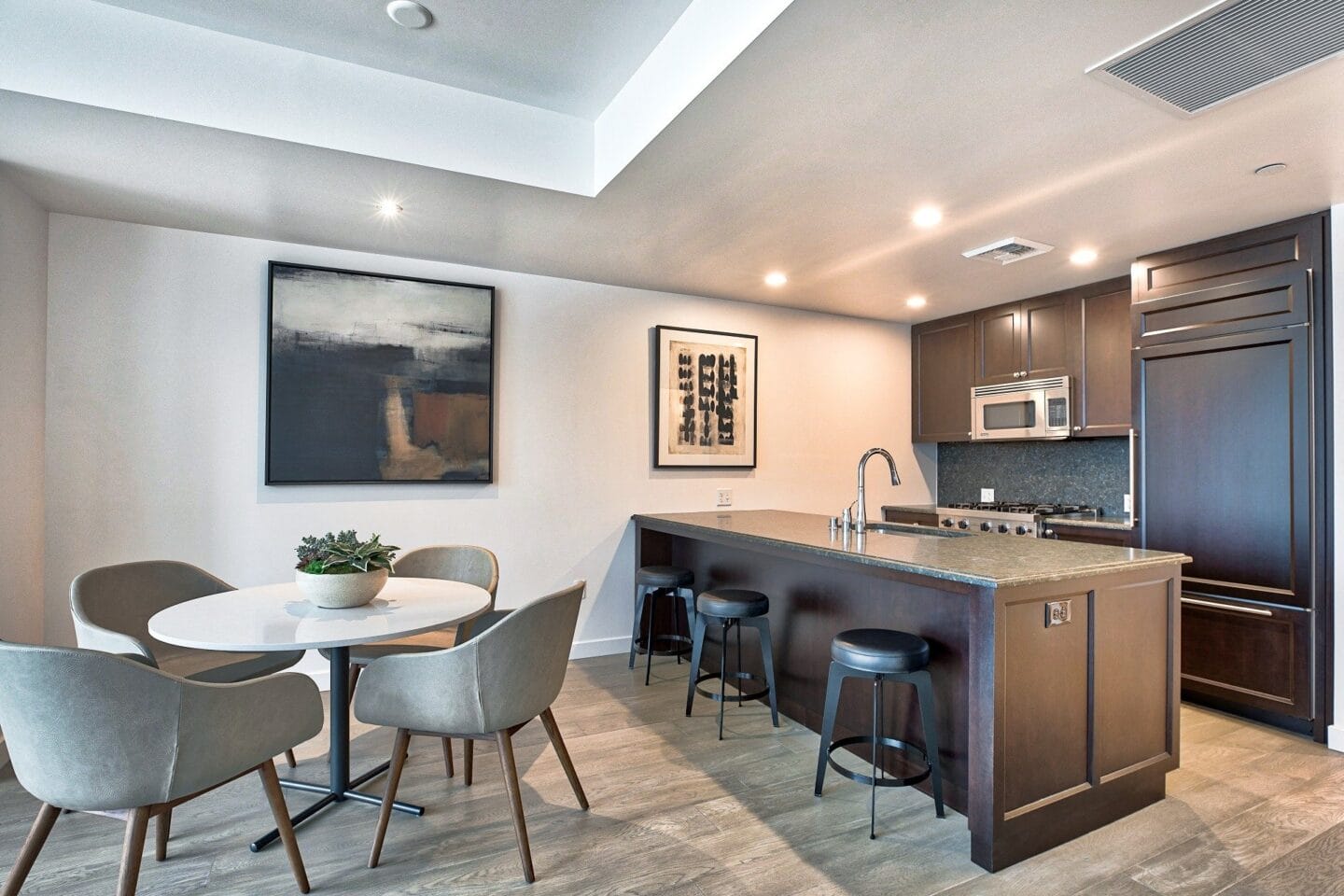 Kitchen with Granite Countertops and Espresso Cabinetry at The Bravern, 688 110th Ave NE, Bellevue