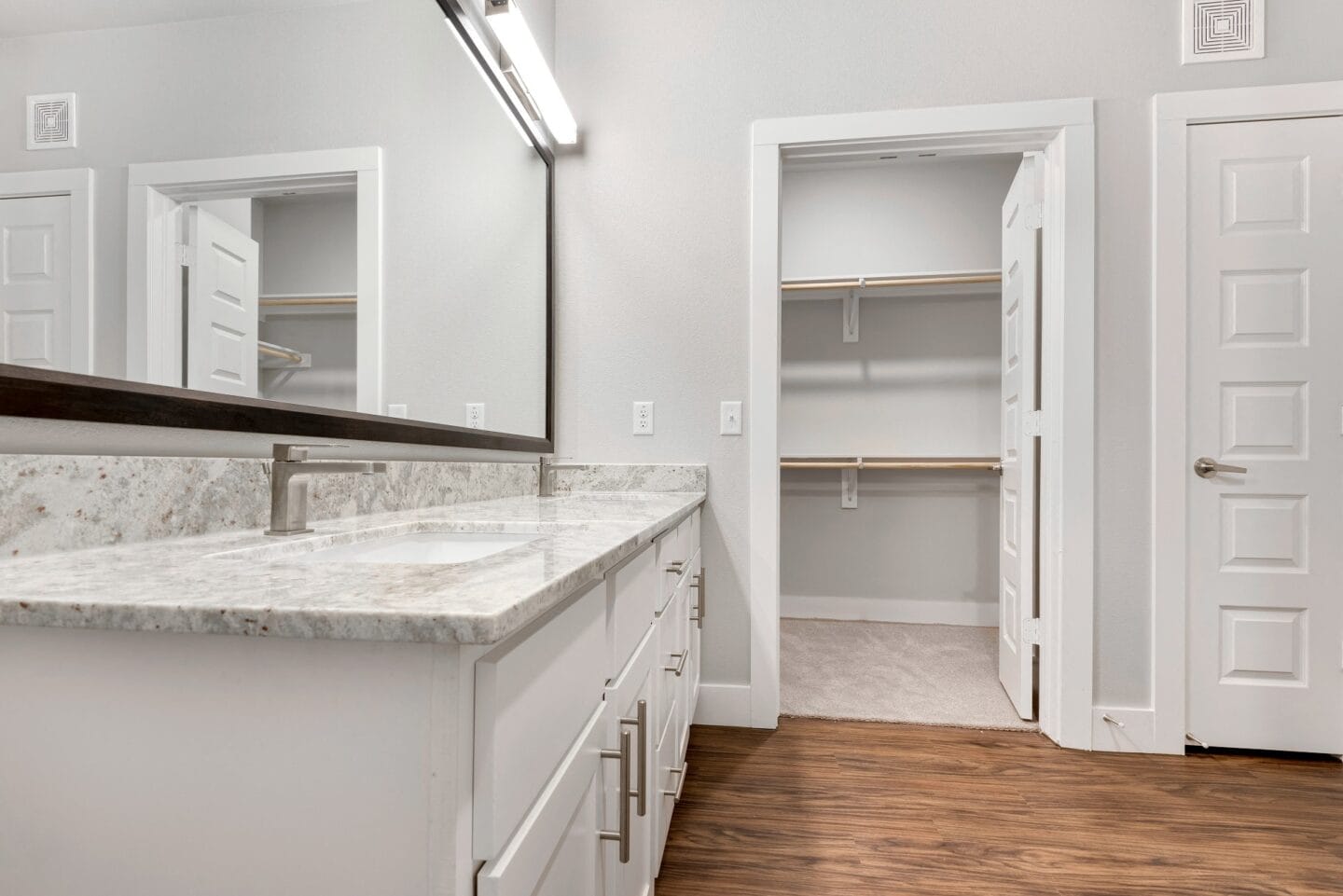 Large mirror vanities and plentiful storage in bathrooms at Windsor Castle Hills, Texas, 75010