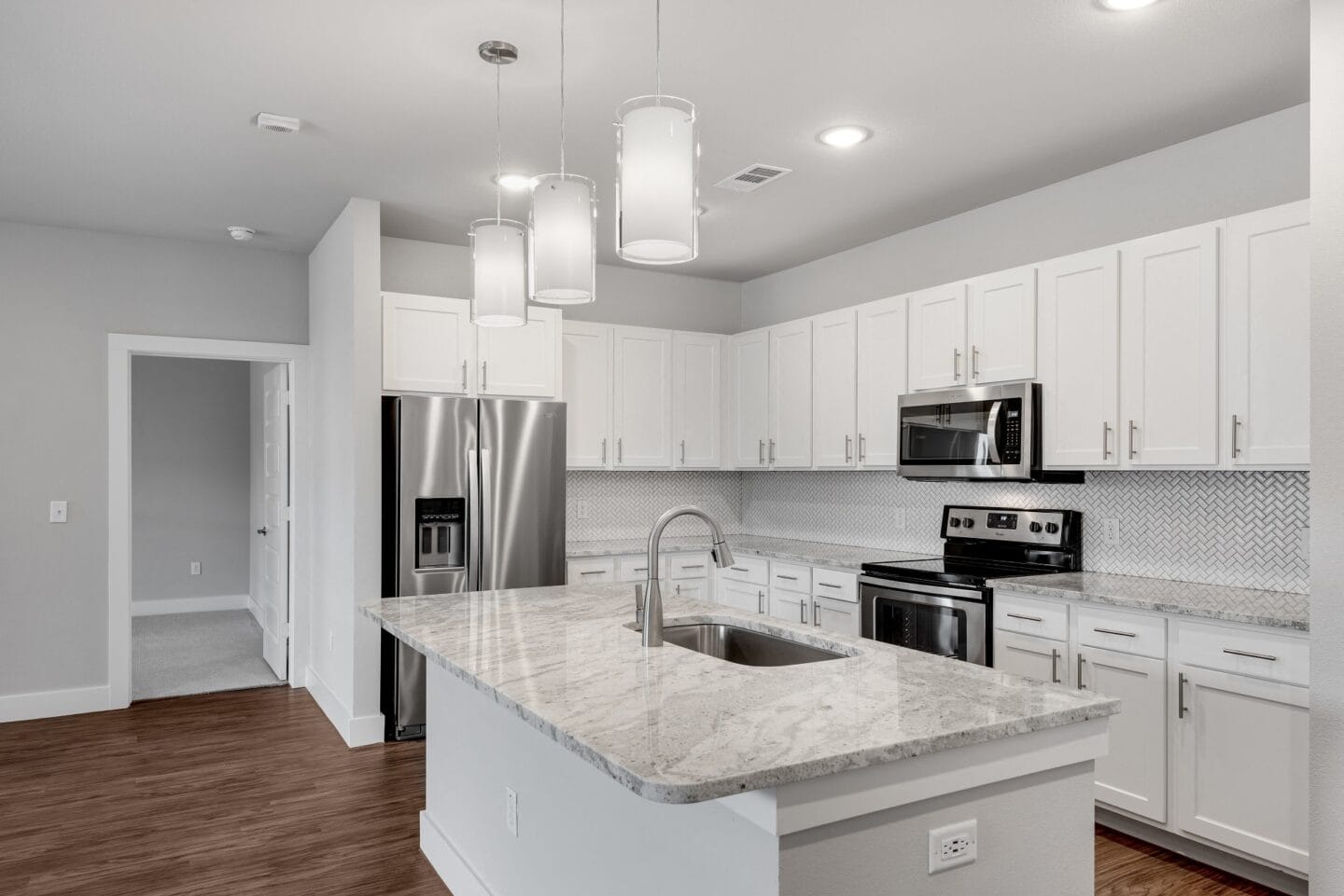 Modern kitchens with stone countertops and tile backsplash at Windsor Castle Hills, Texas