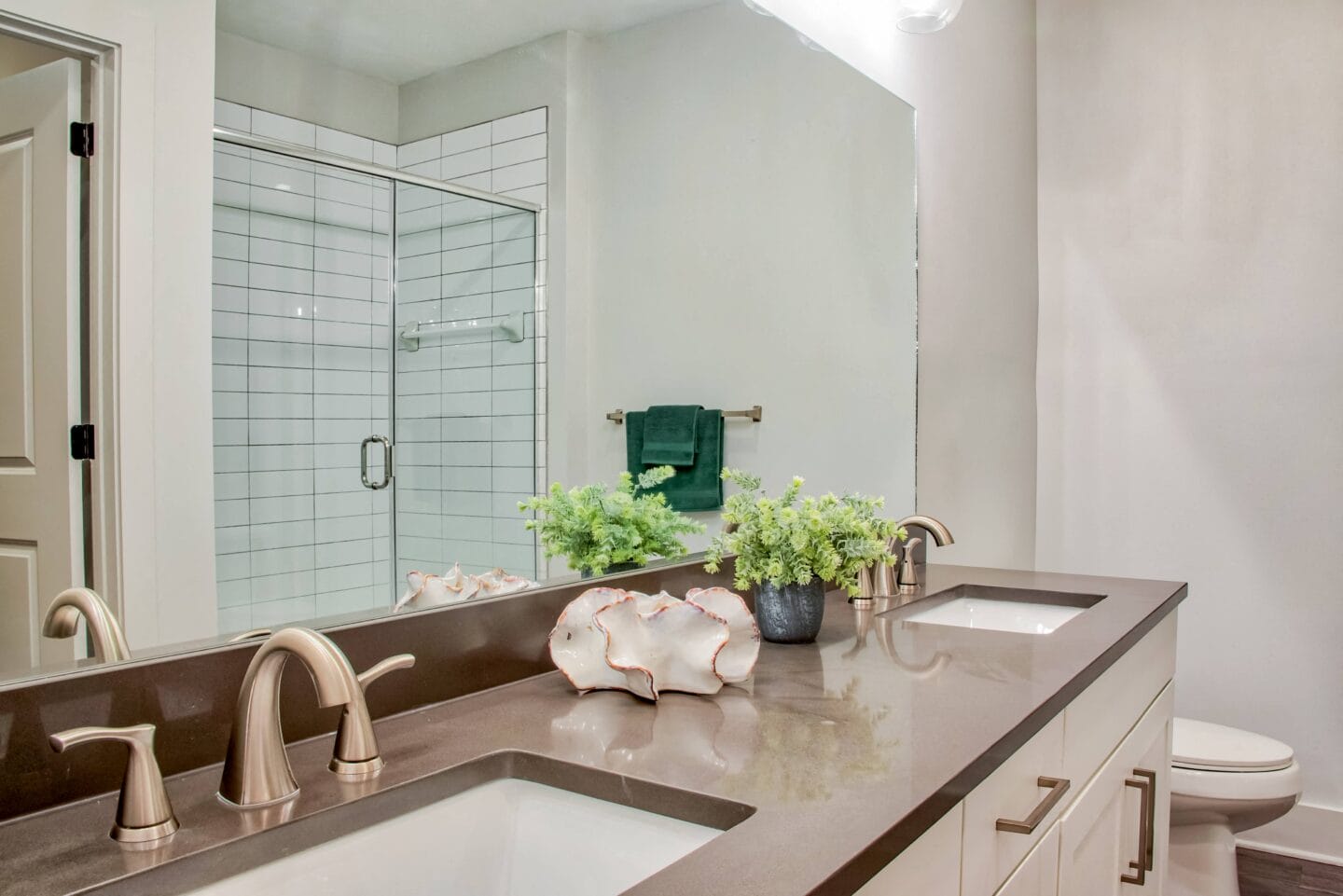 a bathroom with two sinks and a large mirror