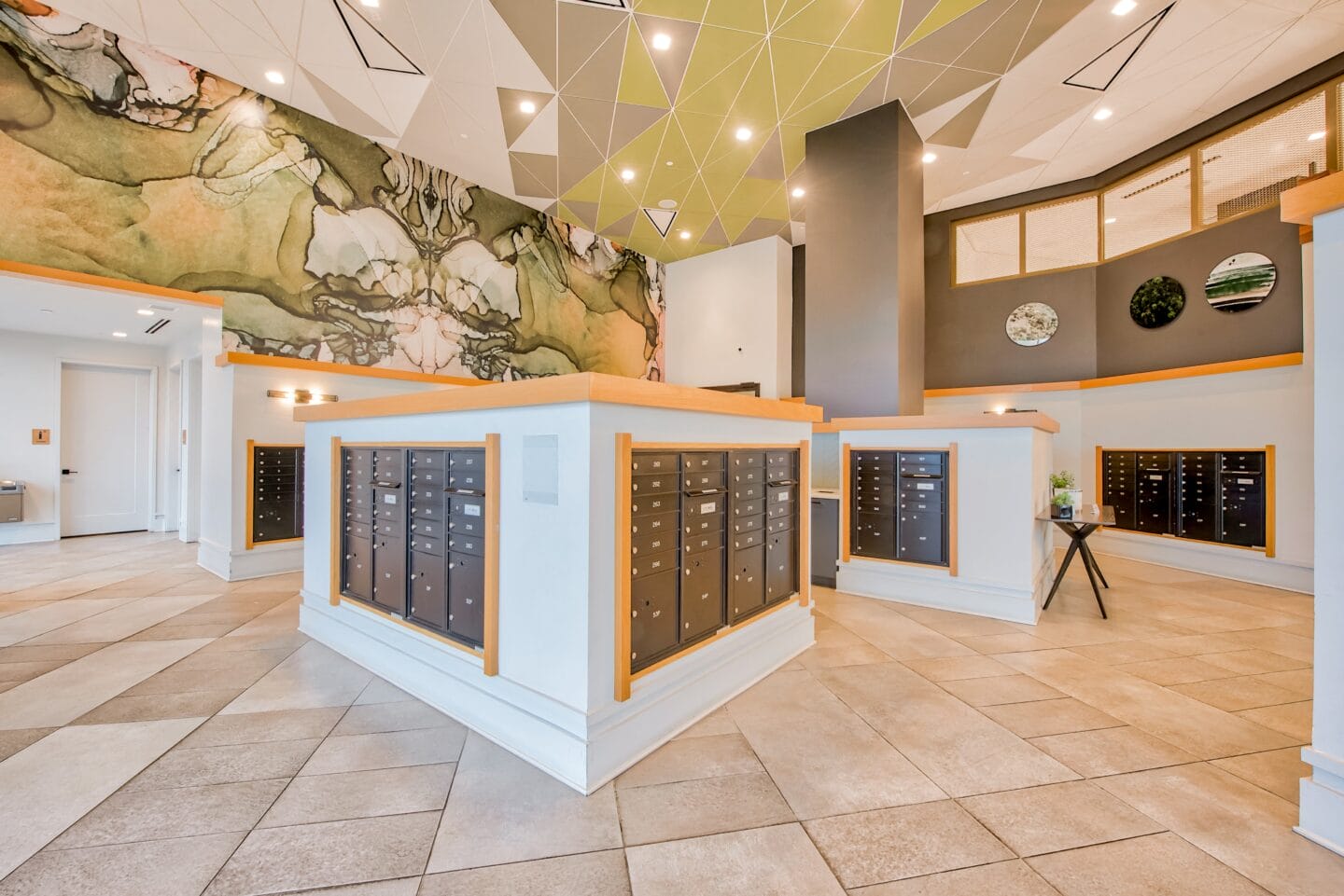 a photo of the main lobby of the building with a large mural of a mountain on the