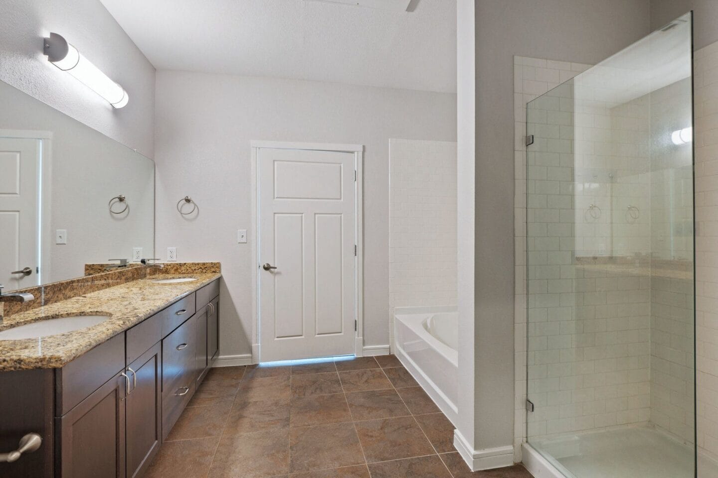 Bathroom with walk in shower and separate tub at Windsor on the Lake, 43 Rainey Street Austin, TX 78701