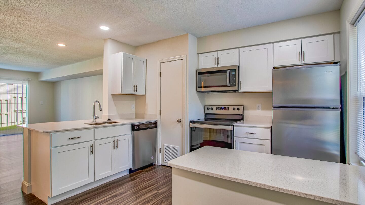 a kitchen with white cabinets and stainless steel appliances and abundant storage space at Windsor Ridge at Westborough, 1 Windsor Ridge Drive, Westborough