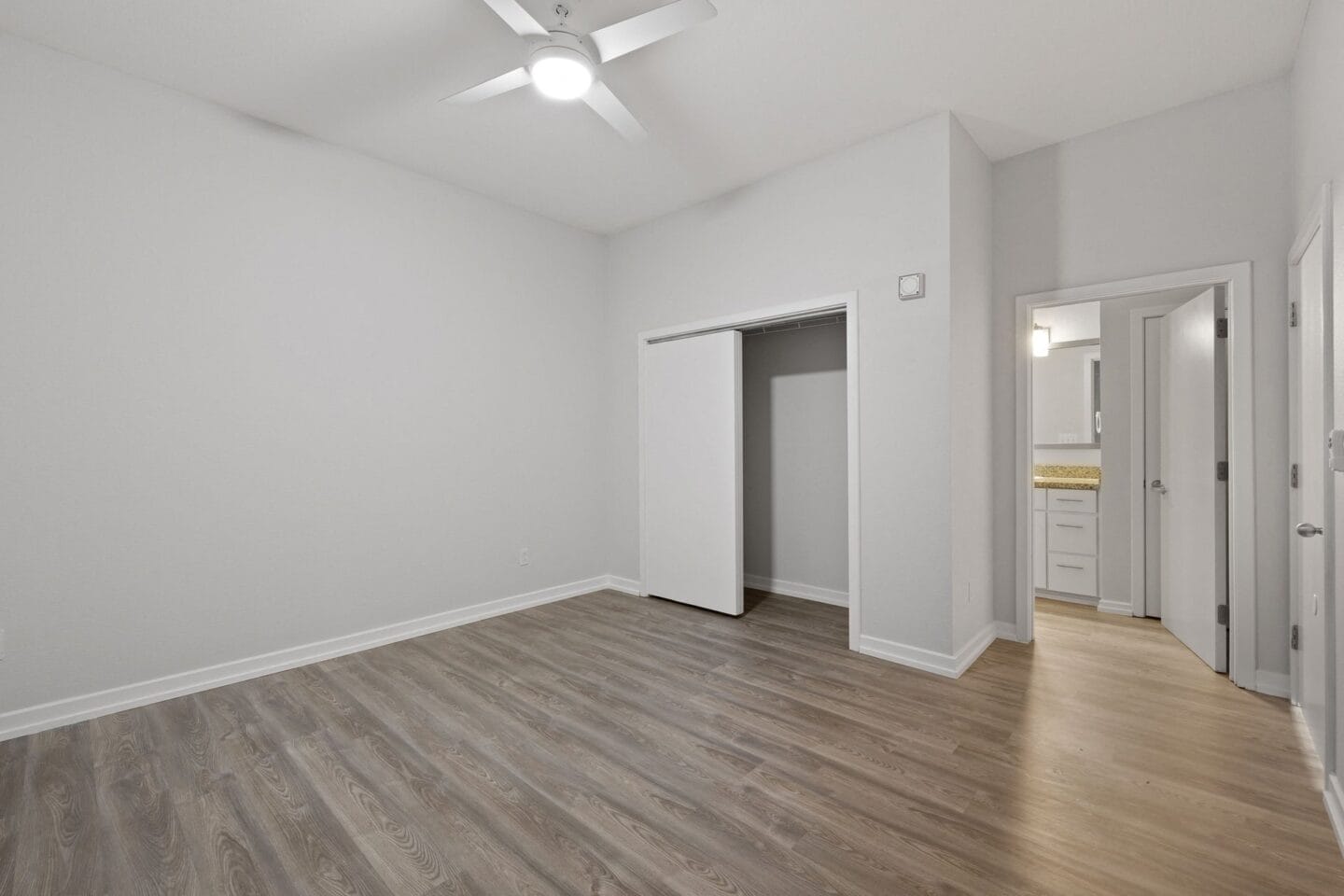 A bedroom with hardwood floors The Monarch by Windsor, Austin, TX