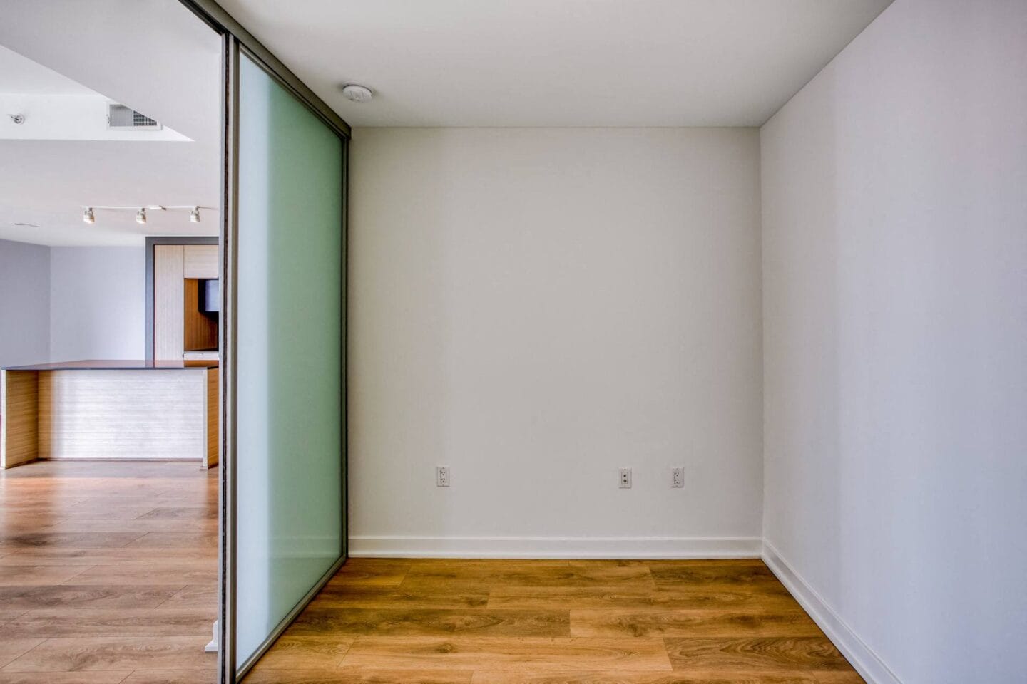 Den space with glass door and hardwood floors