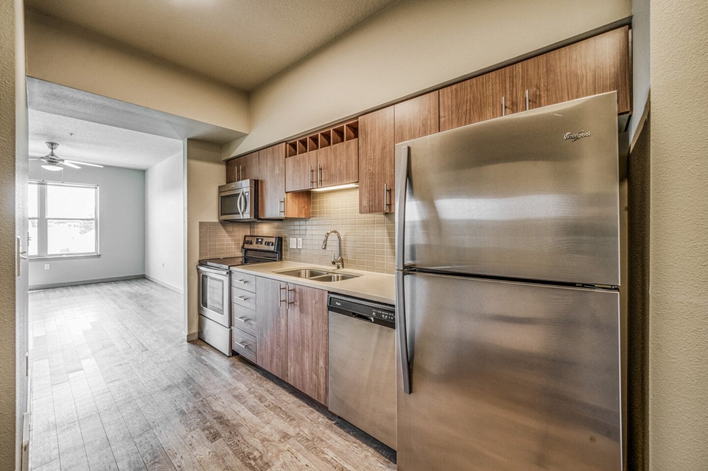 A kitchen with wooden cabinets and stainless steel appliances  at Platform 14, Hillsboro, OR