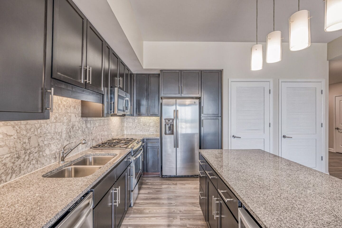 a kitchen with granite countertops and stainless steel appliances